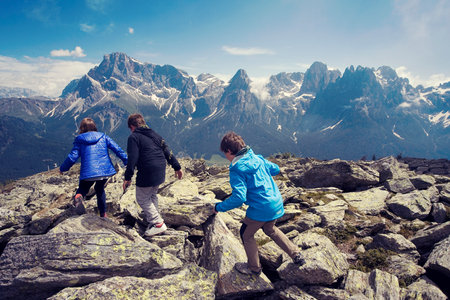 Boys and girls play and run on the mountainの写真素材