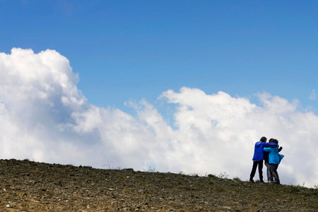Boys and girls play and run on the mountainの写真素材
