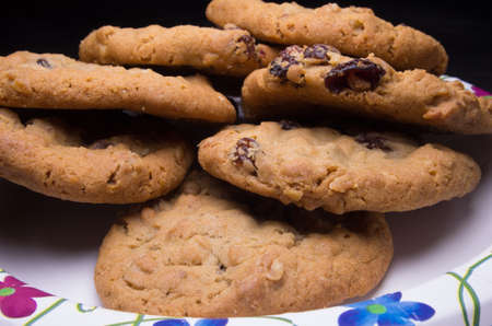 Oatmeal raisin cookies on a plate, ready to be served to hungry guests.