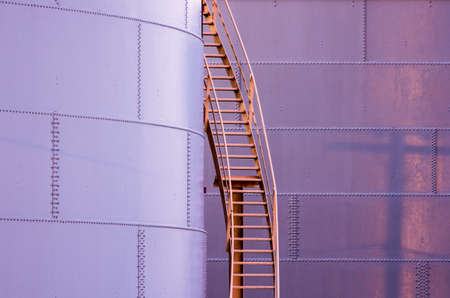 A ladder leads up the side of a storage tank.の写真素材