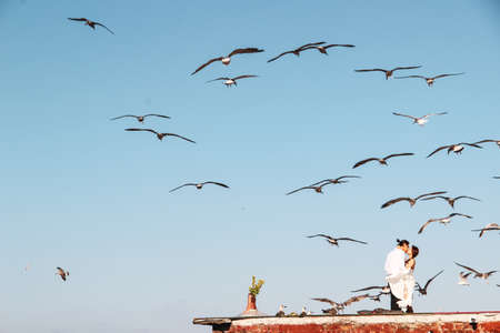 Lovely couple hugging on the roof with seagull background at Bosphorus in Istanbulの写真素材