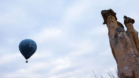 Hot air balloon and fairy chimney in Pasabag Valley, Cappadocia, Turkeyのeditorial素材