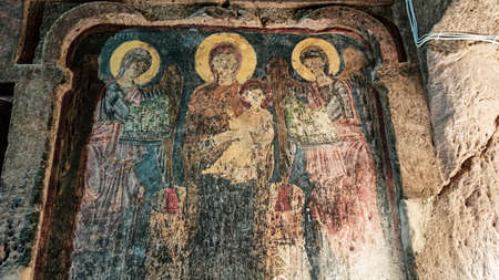 Gumusler Monastery from inside. Sacred Frescos on the wall of the Cave Church in Cappadociaのeditorial素材
