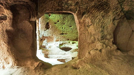 Ancient stone cave houses carved into the volcanic rock in Cappadocia, Turkey