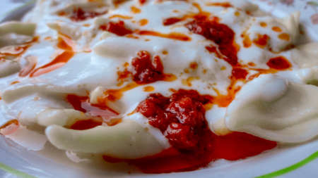 Traditional Turkish cuisine Ravioli, Manti Manlama serving with yogurt and fried butter sauce.の写真素材