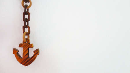 Decorative wooden chain ship anchor symbol on the white background