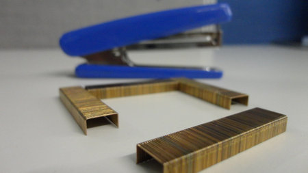 Metal staples for stapler isolated on the white office table. Office accessories on a white...