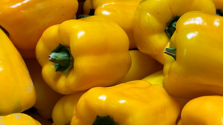 Close up of yellow bell pepper on display at a farmers market.