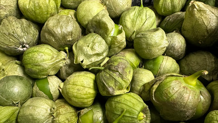 Close up of fresh green tomatillos in a supermarket display.の写真素材