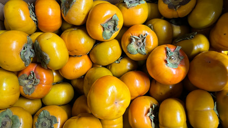 Persimmon fruit in the market, close up of persimmonの写真素材