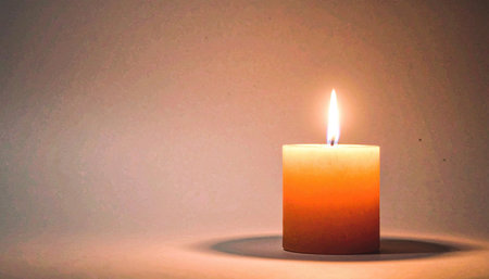 Surreal minimalist halloween concept featuring single floating orange candle flame without visible wickの素材