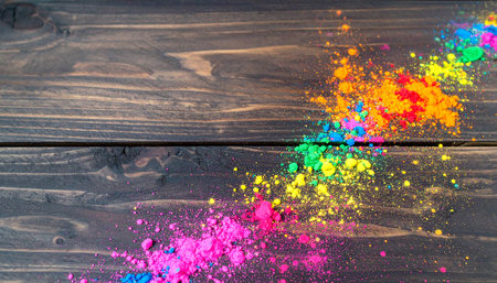 Realistic vibrant holi powders scattered on rustic dark wooden surface with colorful textures and detailsの素材