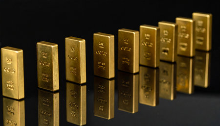 Domino pieces with embedded gold bars and small market icons toppling in a chain reaction on a reflective black surface, illustrating economic ripple effectsの素材