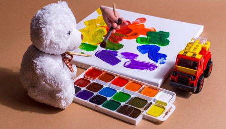 Action shot of a teddy bear rescuing a kitten plush from fire, toy fire truck nearbyの素材