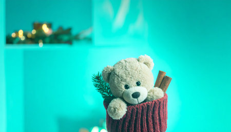 Close up of a plush teddy bear peeking out from a knitted red stocking, pine needles and cinnamon sticks scattered on fireplace mantel, warm holiday lighting.の素材