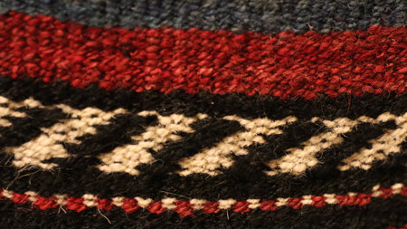 Knitted woolen fabric texture background. Close up of red, black and white striped yarns.の写真素材