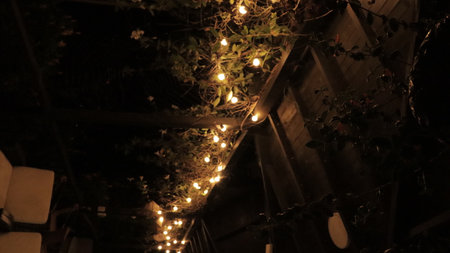 Lights on the roof of an old wooden house at night.