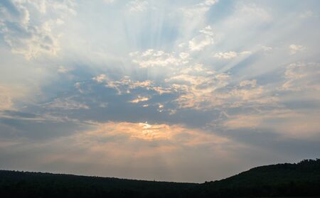 Sky sunset behind the mountainsの写真素材