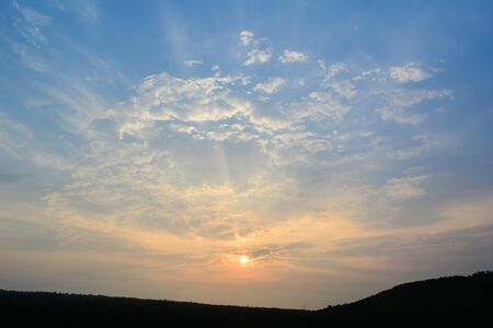 Sky sunset behind the mountainsの写真素材