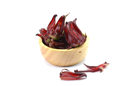Roselle fruit red in wood bowl on white backgroundの写真素材