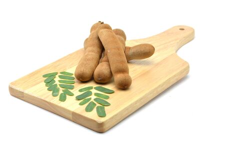 Tamarind isolated in wooden cutting boards on white backgroundの写真素材