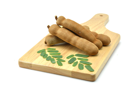 Tamarind isolated in wooden cutting boards on white backgroundの写真素材