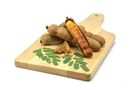 Tamarind isolated in wooden cutting boards on white backgroundの写真素材