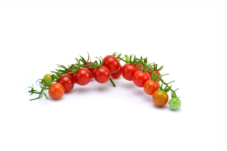 fresh tomatoes with green leaves isolated on white backgroundの写真素材