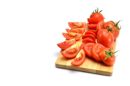 fresh tomatoes with green leaves isolated on white backgroundの写真素材
