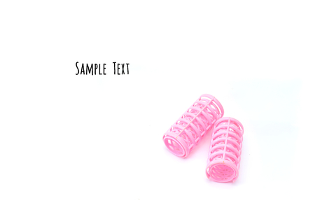 Pink hair curlers isolated on white backgroundの写真素材