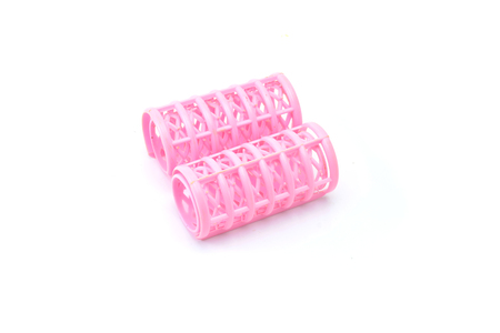 Pink hair curlers isolated on white backgroundの写真素材