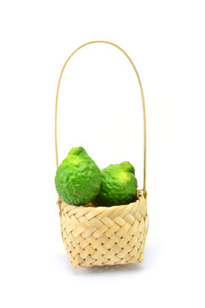 Bergamot fruit in basket isolated on white backgroundの写真素材