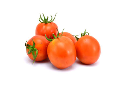fresh tomatoes with green leaves isolated on white backgroundの写真素材