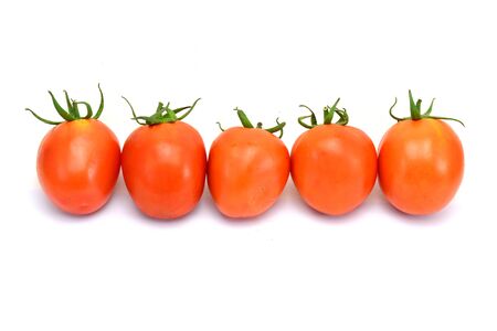 fresh tomatoes with green leaves isolated on white backgroundの写真素材