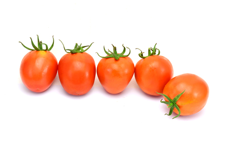 fresh tomatoes with green leaves isolated on white backgroundの写真素材