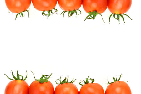 fresh tomatoes with green leaves isolated on white backgroundの写真素材