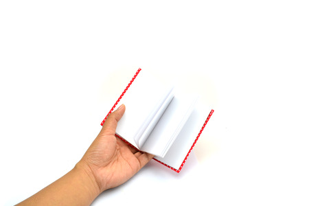 hands hold the red book(diary) empty spread isolated whiteの写真素材