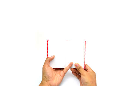 hands hold the red book(diary) empty spread isolated whiteの写真素材