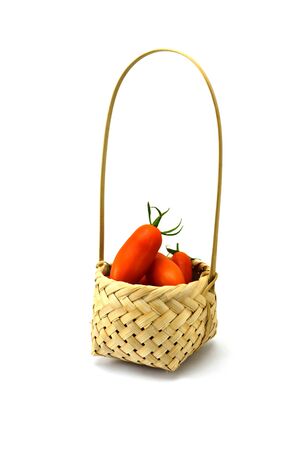 Tomato in basket wood on white backgroundの写真素材