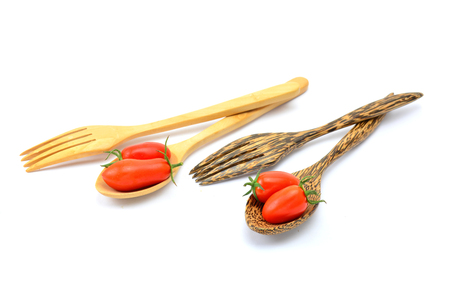 Tomato in wood spoon on white backgroundの写真素材