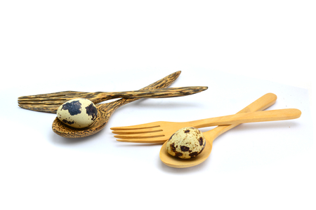 Quail eggs in spoon on wood backgroundの写真素材