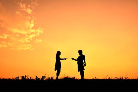 Silhouette children playing at sunsetの写真素材