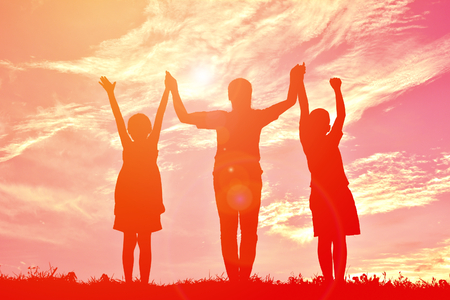 Silhouettes happy family playing at sunset. Concept mother dayの写真素材