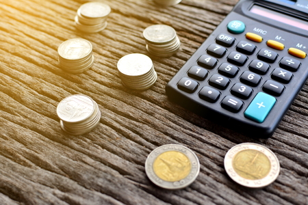 calculator with money on wood backgroundの写真素材