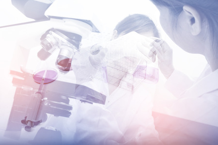 Double exposure of  science experiment hand holding test tube in the laboratory. vintage styleの写真素材