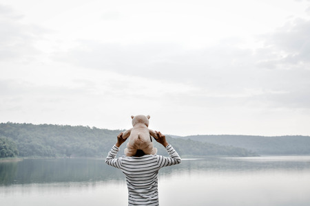 Happy asian children with teddy bear in nature ,relax time on holiday , vintage tone and soft focusの写真素材