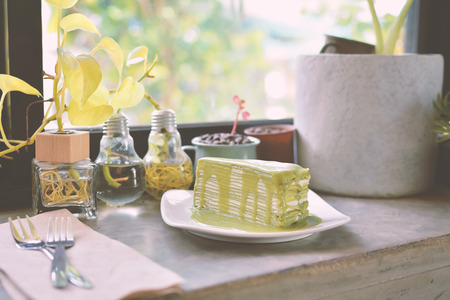 Green tea cake in the coffee shop. hipster tone and selective focusの写真素材