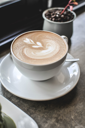 hot coffee latte art in coffee shop.selective and soft focusの写真素材