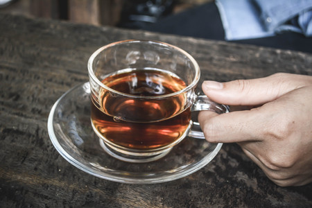 Women drinking hot coffee latte in coffee shop.selective focus and hipster toneの写真素材
