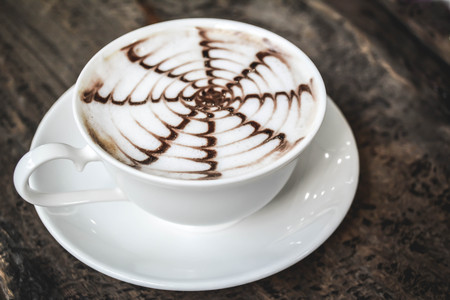 hot coffee latte in coffee shop.selective focus and hipster toneの写真素材